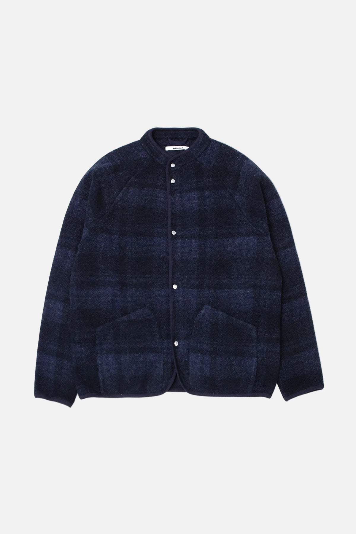 A dark navy blue plaid jacket with a stand collar, button front, and two front patch pockets, displayed flat against a light gray background.