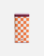 A rectangular metal tin with a white and orange checkerboard pattern, a dark plum purple lid, and a small stylized 'H' logo near the bottom, set against a plain white background.