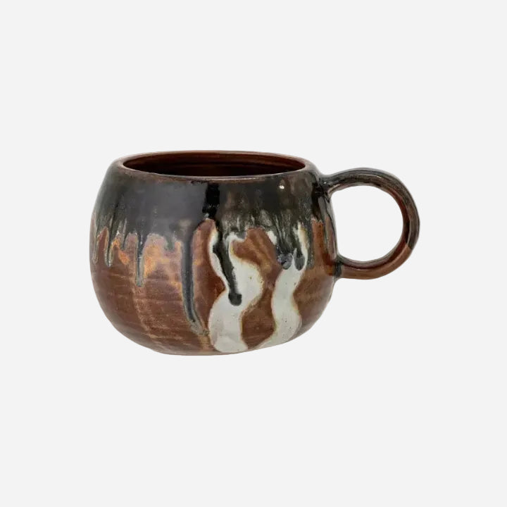 Brown ceramic mug with marbled design on a white background