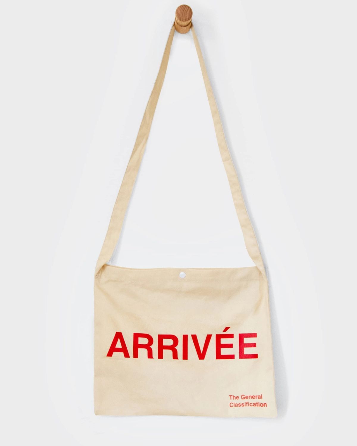 Beige tote bag with 'ARRIVéE' in red text on a white background
