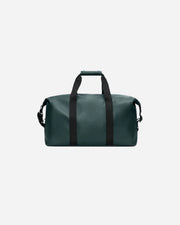 Green duffel bag with black straps on a white background