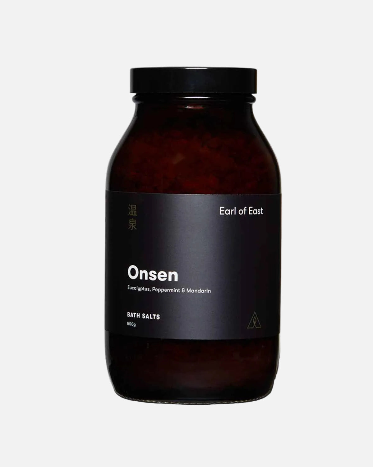 A dark amber glass jar of Earl of East Onsen bath salts with a black lid and a black label, shown on a clean white background.