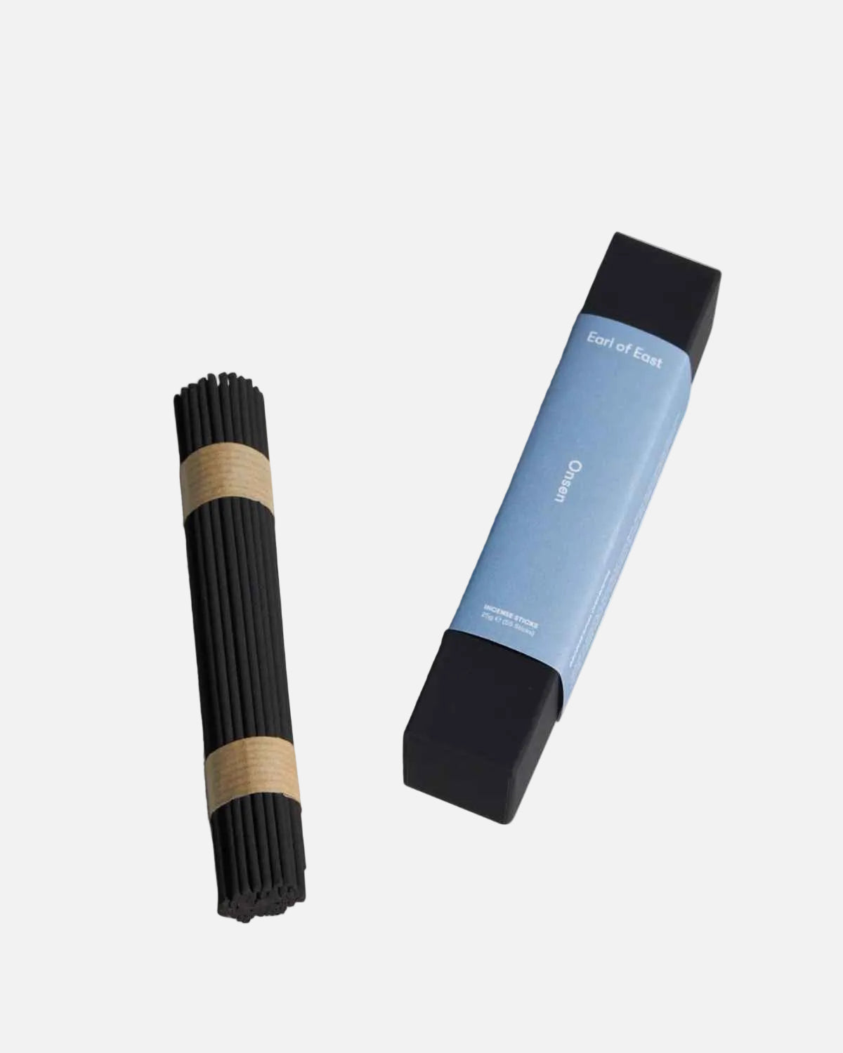A bundle of black incense sticks wrapped with tan paper bands, shown next to its blue and black rectangular packaging box on a clean white background.