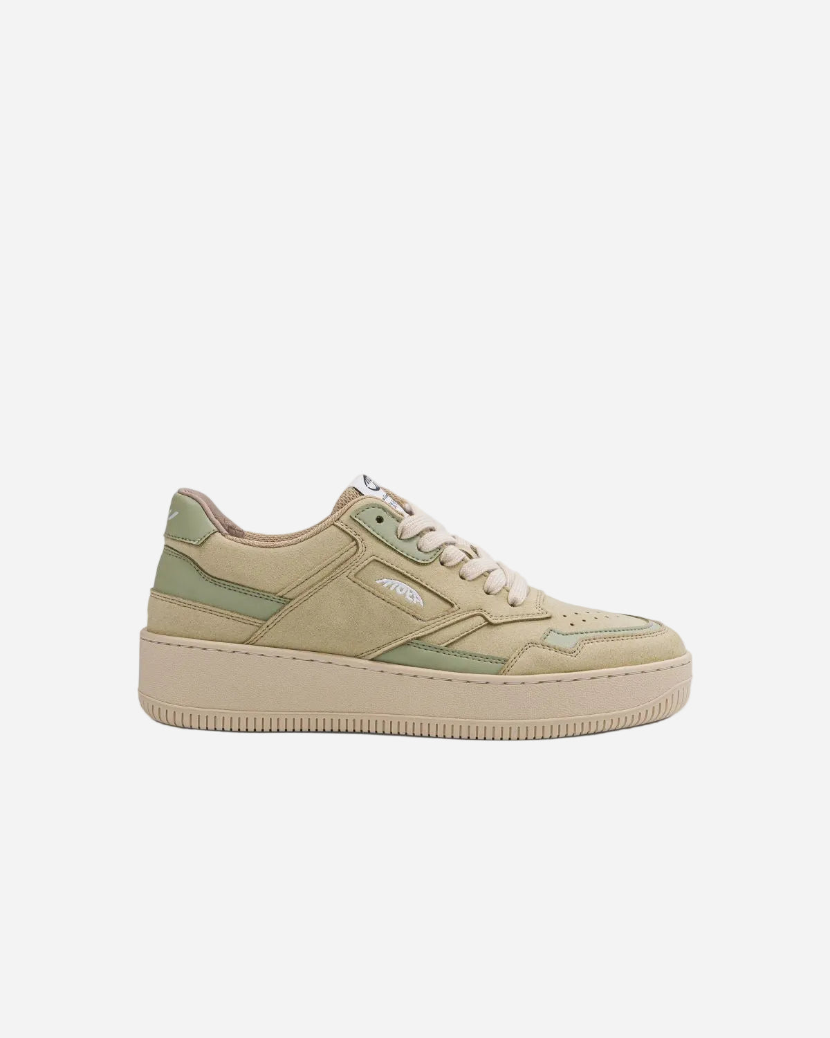 Beige sneaker with green accents on a white background