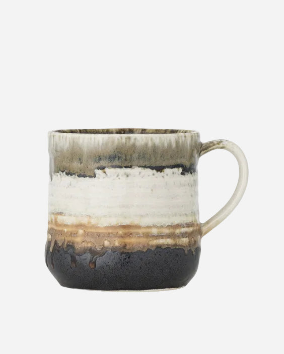 ceramic mug with striped design on a white background