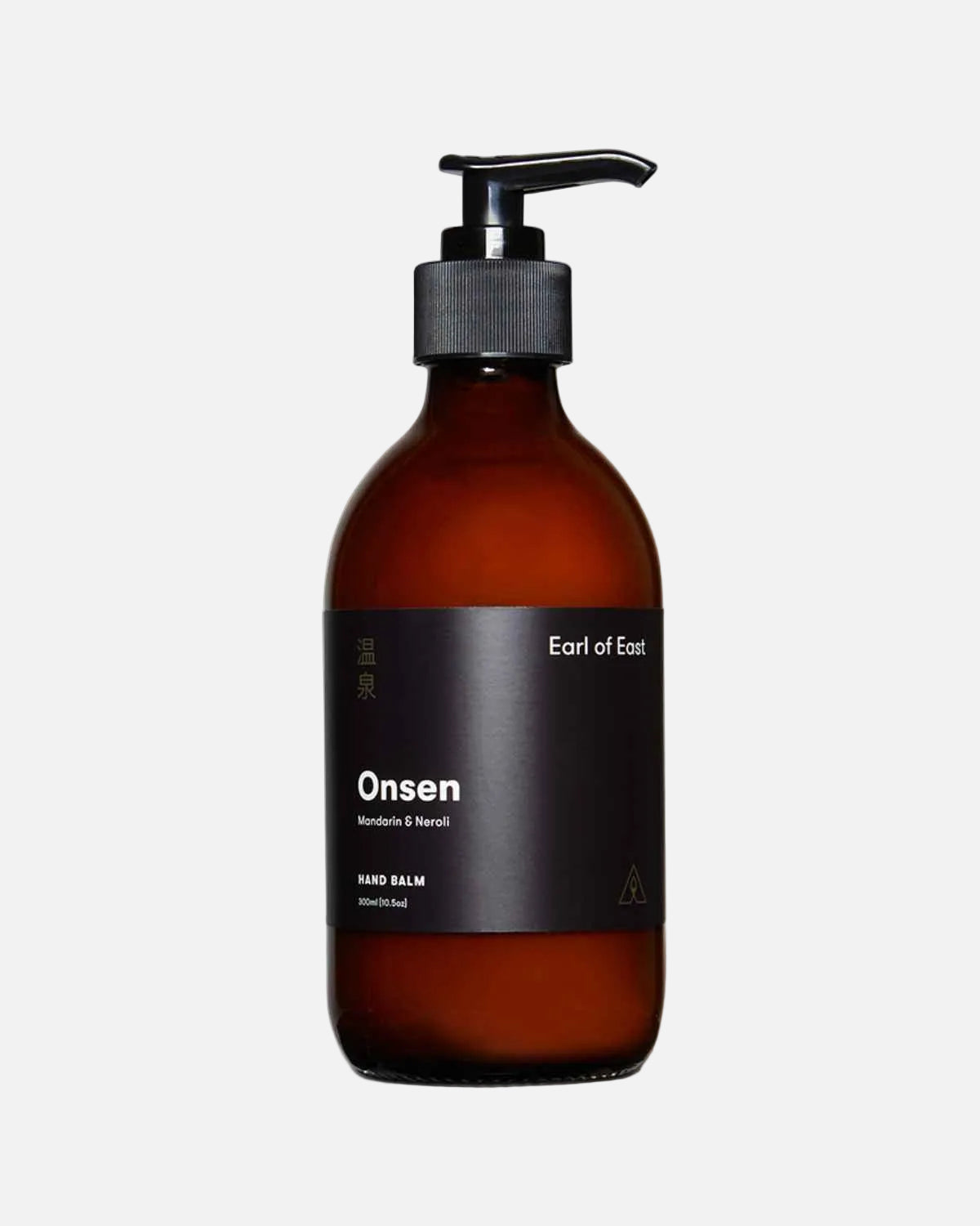 An amber glass hand balm bottle with a black pump dispenser and a black label reading 'Onsen' and 'Ear of East', shown on a clean white background.
