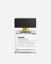 Perfume bottle with black cap and white label on a white background