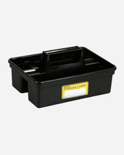 Black storage caddy with a yellow label on a white background