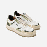 Pair of white and green sneakers with 'MOEA' branding on a light gray background