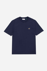 Navy blue t-shirt with a small logo on a light gray background