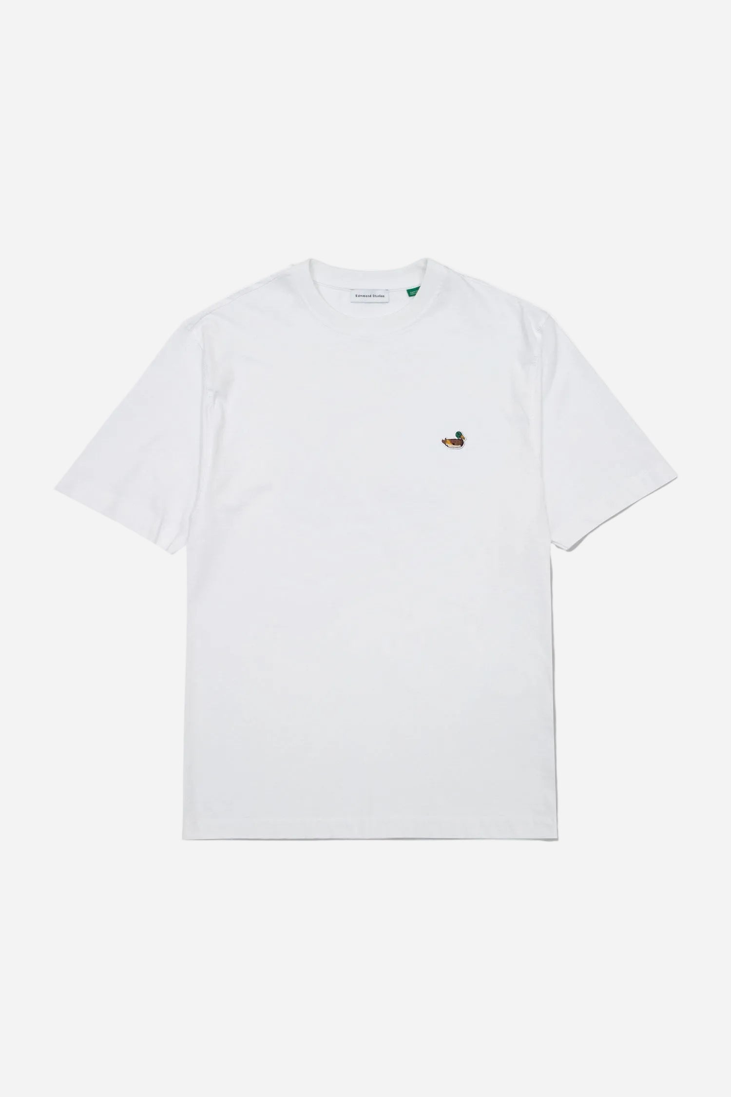 White t-shirt with a small embroidered design on a white background