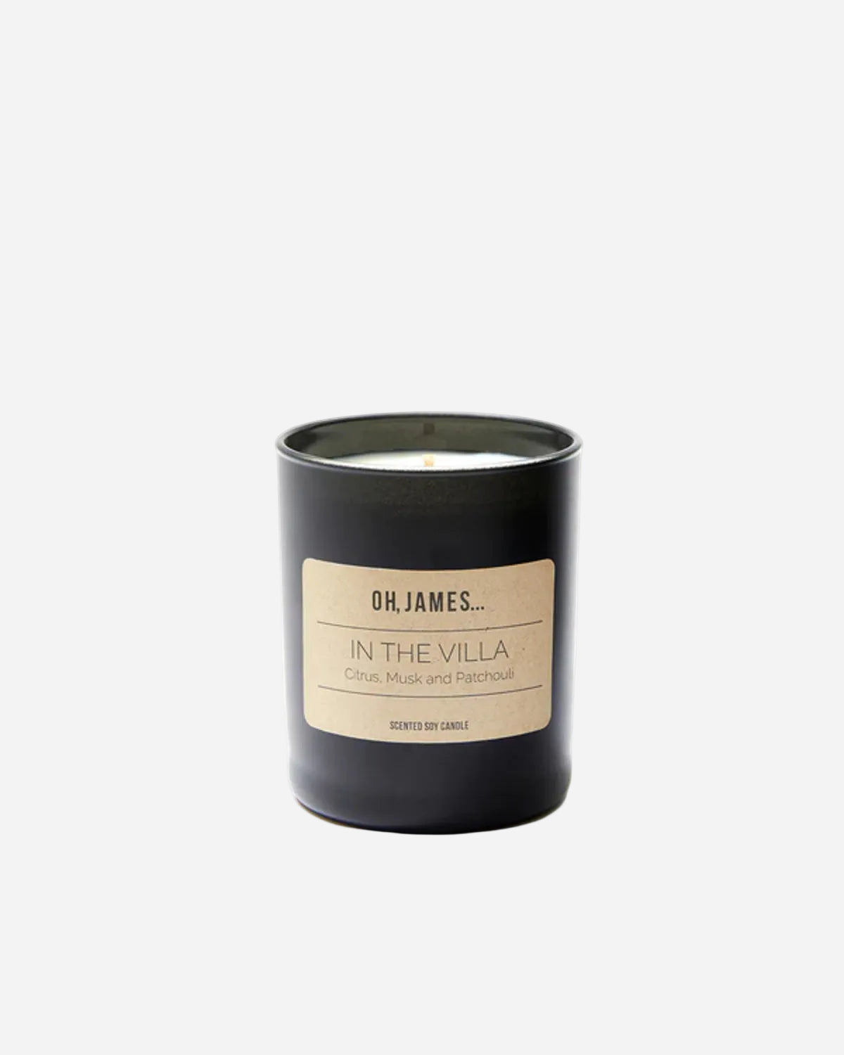 Black candle with a beige label on a white background