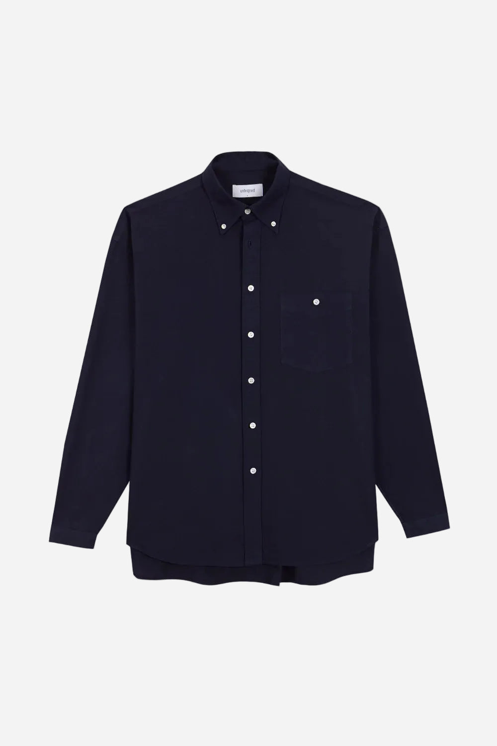 Navy shirt with white buttons on a light gray background