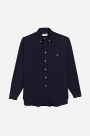 Navy shirt with white buttons on a light gray background