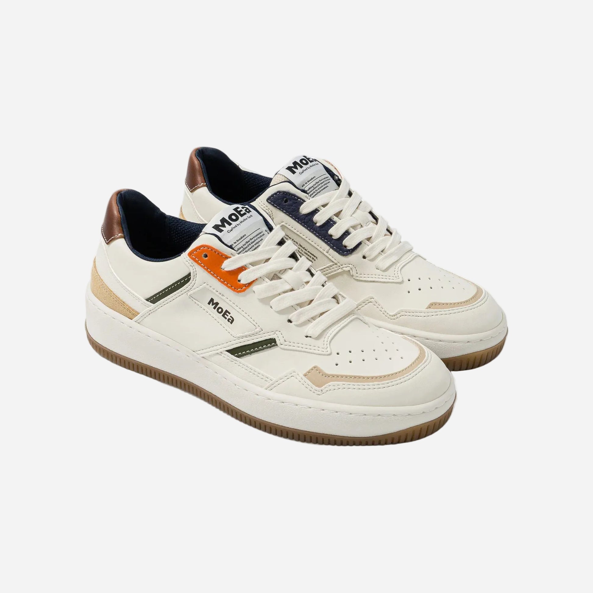 Pair of white sneakers with brown accents on a white background