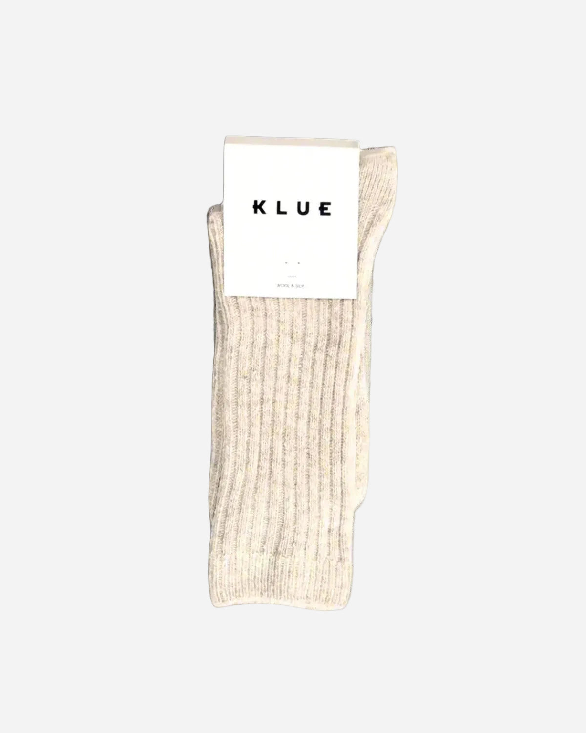 Beige sock with a KLUE label on a gray background