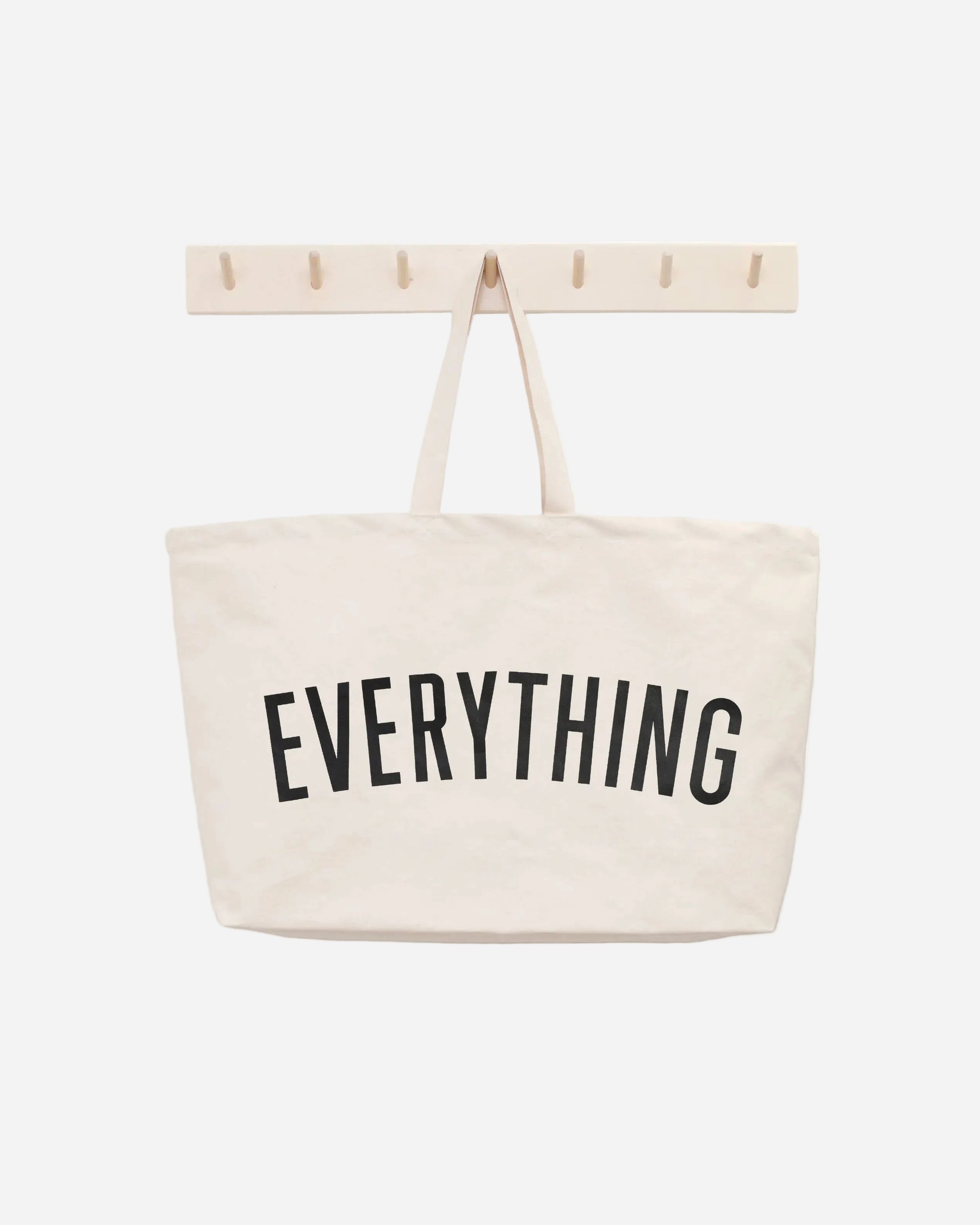 Beige tote bag with 'EVERYTHING' text on a white background