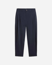Navy blue pleated pants on a white background