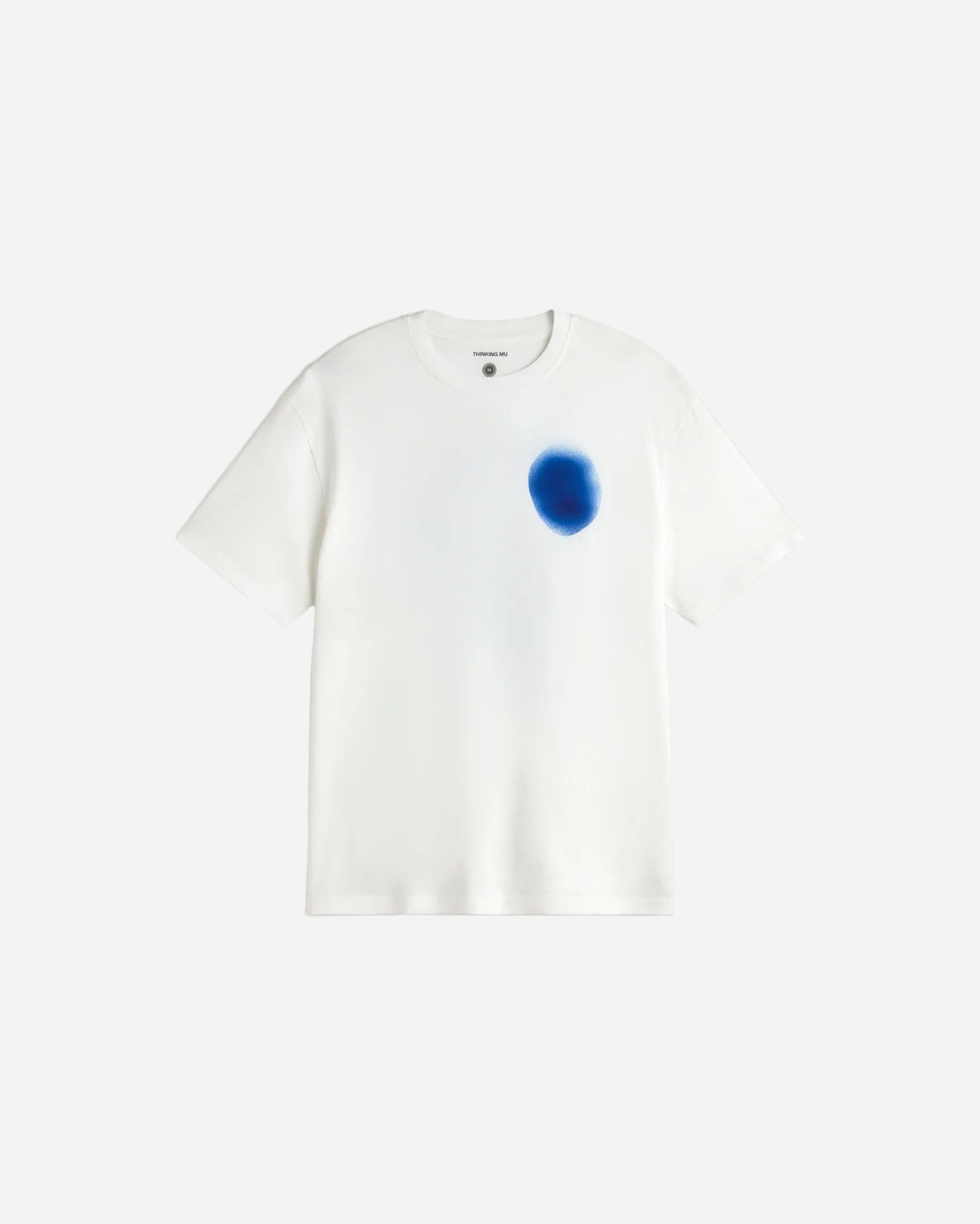 White t-shirt with a blue stain on a light gray background