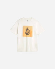 White t-shirt with a shell graphic on a light gray background