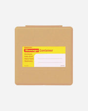 Brown storage container with a yellow label on a white background